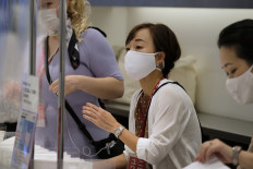 Hot but want to stop the virus? Japan keeps mask-wearing cool in summer