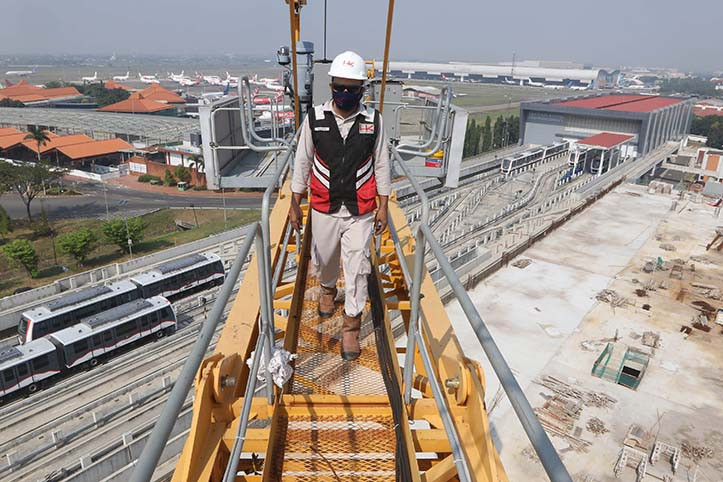A worker prepares to operate a tower crane at the Soekarno-Hatta International Airport integrated building construction project in Tangerang, Banten, on July 29, 2020. 
