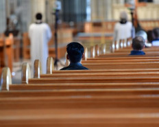 People take part in a religious service in the nearly empty Uppsala Cathedral in Uppsala, Sweden on 'Good Friday' on April 10, 2020, amidst the new coronavirus COVID-19 pandemic.