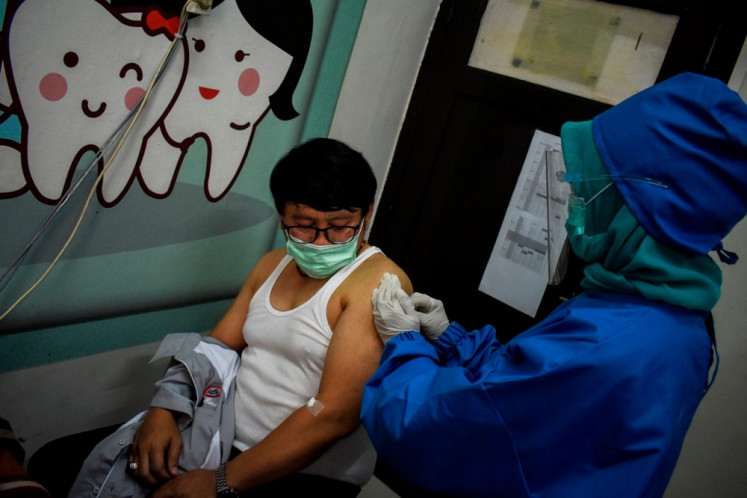 A volunteer receives an injection of a COVID-19 vaccine candidate during a phase III trial in Bandung, West Java, on Aug. 14.