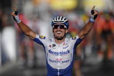 Team Deceuninck rider France's Julian Alaphilippe celebrates as he crosses the finish line to win the 2nd stage of the 107th edition of the Tour de France cycling race, 187 km between Nice and Nice, on Sunday.