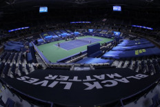 A Black Lives Matter banner is shown in the foreground as Naomi Osaka of Japan serves during her Womens Singles first round match against Misaki Doi of Japan on Day One of the 2020 US Open at the USTA Billie Jean King National Tennis Center on August 31, 2020 in the Queens borough of New York City.   