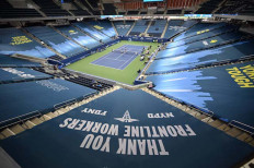A tarp reading, 'Thank you frontline workers,' covers the seats at Louis Armstrong Stadium in each corner on Tuesday. The day before the same seats were covered with 'Black Lives Matter' at the USTA Billie Jean King Tennis Center. 