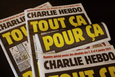 This picture taken on September 1, 2020 in Paris shows covers of French satirical weekly Charlie Hebdo reading 'All of this, just for that,' to be published on September 2 to mark this week's start of the trial for 14 accused in January 2015 jihadist attacks in Paris. 