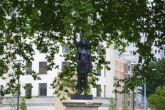 A picture shows a sculpture by British artist Marc Quinn in collaboration with Bristol resident Jen Reid showing Jen Reid with an arm raised in a Black Power salute entitled ‘A Surge of Power (Jen Reid) 2020’, on the vacant Edward Colston statue plinth in Bristol, southwest England, on July 15, 2020.
