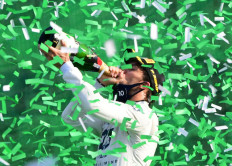 AlphaTauri's Pierre Gasly drinks champagne at the podium as he celebrates winning the Italian Grand Prix  at the Autodromo Nazionale Monza, Monza, Italy on Sept. 6, 2020.