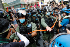 Hong Kong police fire pepper balls at protesters opposed to election delay, new law