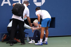 Novak Djokovic of Serbia tends to a lineswoman after inadvertently striking her with a ball hit in frustration during his Men's Singles fourth round match against Pablo Carreno Busta of Spain on Day Seven of the 2020 US Open at the USTA Billie Jean King National Tennis Center on September 6, 2020 in the Queens borough of New York City. Djokovic was defaulted from the match.   