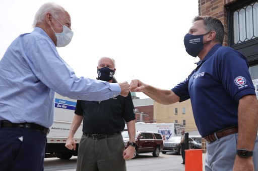 Democratic presidential nominee Joe Biden (L) greets local labor leaders ahead of a virtual event at the union's state headquarters on Labor Day, September 07, 2020 in Harrisburg, Pennsylvania. Due to the ongoing coronavirus pandemic, Biden's campaign has organized more virtual events, engaging with supporters using video teleconferencing.   