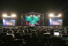 Audience members enjoy a drive-in concert by local pop band Kahitna during the New Live Experience series in the parking area of the Jakarta International Expo in Kemayoran, Central Jakarta, on Saturday August 29.2020. JP/Wienda Parwitasari