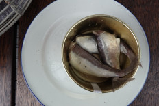 A can of fermented Baltic herring, known as surstromming in Swedish, sits on a table in the restaurant belonging to chef Malin Soderstrom who invited a group of friends to try the delicacy in her restaurant as a demonstration of how she prepares the strong-smelling dish in Skarsa, north of Stockholm, on September 4, 2020.