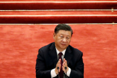 Chinese President Xi Jinping applauds during a meeting to commend role models in China's fight against the COVID-19 outbreak, at the Great Hall of the People in Beijing, China Sep. 8, 2020.