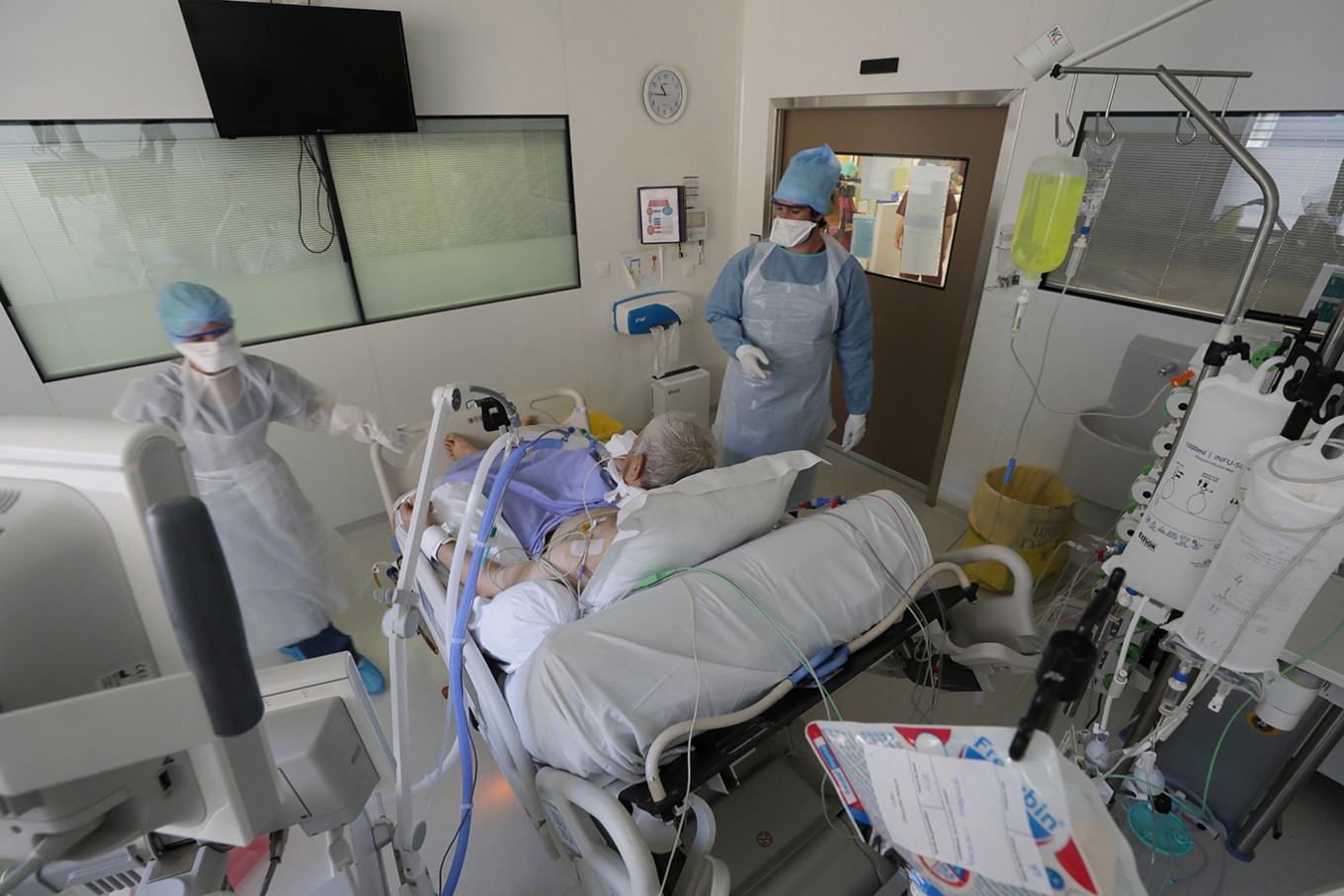 Members of the medical staff, wearing protective suits and face masks, treat a patient suffering from the COVID-19 in the Intensive Care Unit (ICU) at the Hopital Europeen hospital in Marseille, France, Sept. 8, 2020.  
