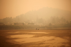 Crews battle wildfires in US West as smoke travels the world