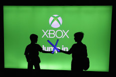 In this file photo young XBox game enthusiasts play with toy light sabers during the E3 Video Game Convention at the Microsoft Theater on June 11, 2019 in Los Angeles, California. 