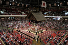 This file photo taken on July 19, 2020 shows spectators observing social distancing while watching a ceremony ahead of bouts during a sumo tournament at the Ryogoku Kokugikan, the main sumo arena in Tokyo. - A coronavirus outbreak at a sumo stable in Tokyo has infected 19 people, the governing body said September 10, 2020, adding that a tournament will go ahead as planned. The Japan Sumo Association said one wrestler and 18 trainees at the Tamanoi stable have tested positive for the virus, with 12 of those infected sent to hospital.