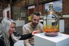 This file photo taken on November 7, 2018 shows visitors reacting to the 'Mouse Wine' from China presented at the Disgusting Food Museum in Malmo, Sweden. 