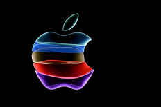 The Apple logo is projected on a screen before the start of a product launch event at Apple's headquarters in Cupertino, California, on September 10, 2019. 