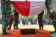 Soldiers hold the Indonesian flag over the grave of Kompas Gramedia Group cofounder Jakob Oetama, at Kalibata Heroes Cemetery in Jakarta on  Sept. 10, 2020. Jakob, who founded Kompas Gramedia in 1965 with his colleague PK Ojong, died the day before at the age of 88. JP/Seto Wardhana.