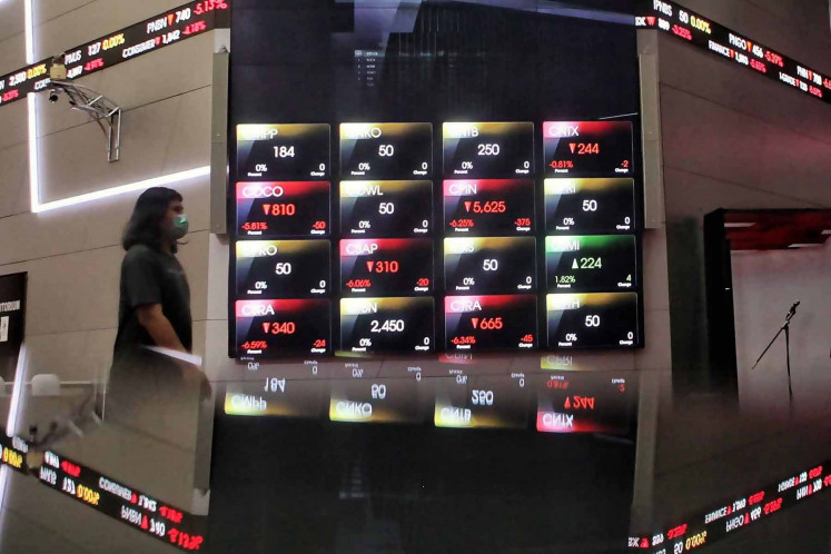 A man walks past an electronic board showing the movement of the Indonesian Composite index (IHSG) at the Indonesia Stock Exchange in Jakarta, Thursday, Sept. 10, 2020. JP/Seto Wardhana