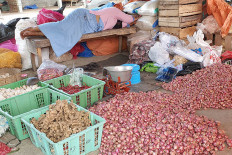 A seller rests at a market in Kulon Progo regency, Yogyakarta, in this undated photo.