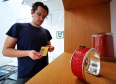 Ictyos co-founder and President Benjamin Malatrait looks at a wallet made of salmon leather at the company's showroom in its workshop in Saint-Fons, near Lyon, France, on September 17, 2020.