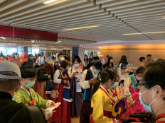 Passengers dressed in traditional Korean Hanbok costumes are seen before boarding a Tigerair Taiwan flight that will circle over South Korea's Jeju Island and then return to Taoyuan, following the global coronavirus disease (COVID-19) outbreak, at Taoyuan International Airport in Taoyuan, Taiwan, on September 19, 2020. 