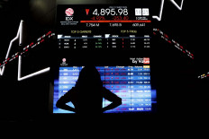 A visitor monitors real-time development of the composite index at the Indonesia Stock Exchange in Jakarta on Sept. 10, 2020. 