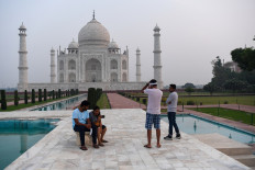 Tourists visit the Taj Mahal in Agra on September 21, 2020. 