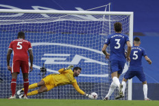 Chelsea's Italian midfielder Jorginho (right) has a penalty saved by Liverpool's Brazilian goalkeeper Alisson Becker during their English Premier League soccer match at Stamford Bridge in London on Sept. 20, 2020.