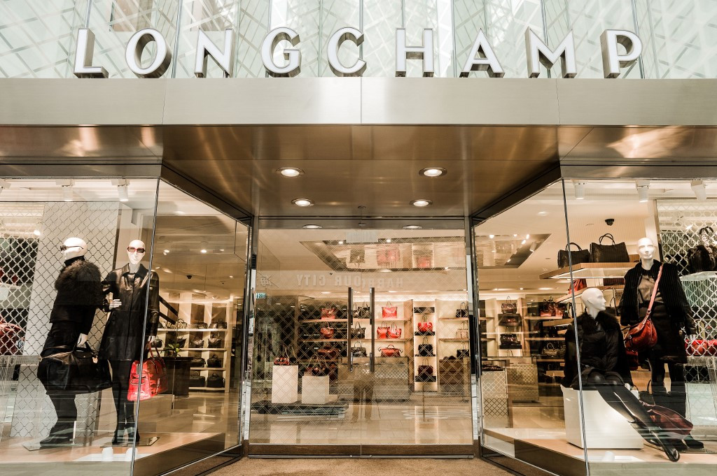 Shoppers walk past the French luxury fashion brand Longchamp store