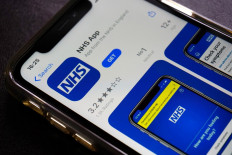 A photograph arranged as an illustration in Hartley Wintney, west of London on August 19, 2020 shows the NHS app, for Britain's NHS (National Health Service) on a smart phone. 