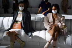 Guests wearing face masks and respecting social distances sits prior Fendi's Spring/Summer 2021 women's and mens collection during the Milan Fashion Week, on September 23, 2020.