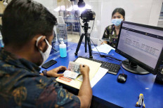 An official processes a passport application at the Central Jakarta Immigration Office.