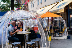 People sit outside Cafe Du Soliel under bubble tents following the outbreak of the coronavirus (COVID-19) in the Manhattan borough of New York City, New York, US, September 23, 2020. 