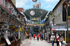 People walk along a street next to shops in Singapore on Sept. 22, 2020.

