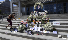 Judy Barnett drops off flowers at a memorial to the late Supreme Court Justice Ruth Bader Ginsburg on September 25, 2020 at the Skirball Cultural Center in Los Angeles, California.
