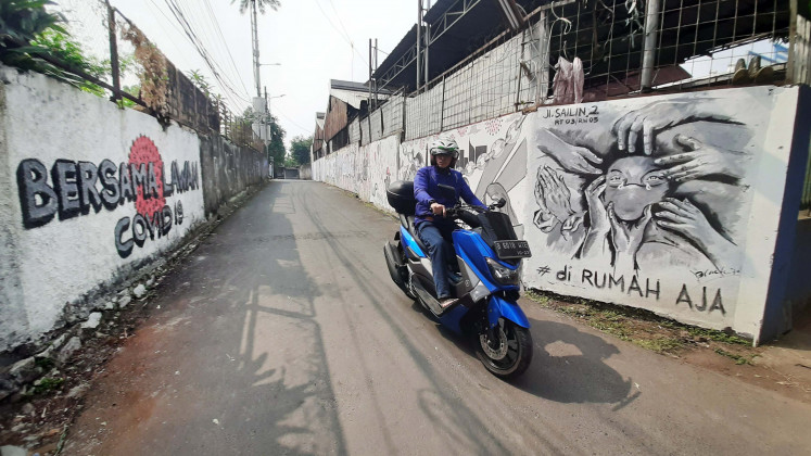 Painted Pathway: Murals adorn both sides of Jl. Sailin.