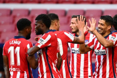 Atletico Madrid's Uruguayan forward Luis Suarez (right) celebrates with teammates after scoring during the Spanish league football match Club Atletico de Madrid  against Granada FC at at the Wanda Metropolitano stadium in Madrid on Sunday.