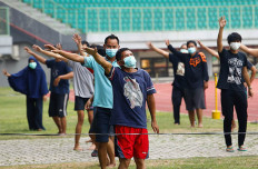 Patients wearing protective face masks exercise at the Patriot Chandrabhaga Stadium, which has been converted into a quarantine house during the COVID-19 outbreak in Bekasi, West Java, on Sept. 28.