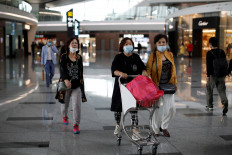 People wearing face masks are seen at the Beijing Daxing International Airport in Beijing, China, on September 25, 2020. 