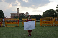Licypriya Kangujam, 8, India's young climate activist, holds a poster during a protest demanding to pass a climate change law outside the parliament in New Delhi, India, on September 23, 2020. 