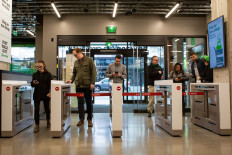 Shoppers scan their phones to enter Amazon Go Grocery on February 26, 2020 in Seattle, Washington. 