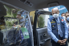 Limited contact: Mayor of Jayapura, Benhur Tomi Mano, about to try a GrabCar Protect service in Jayapura, Papua. The GrabCar Protect unit is equipped with thick plastic partition of high quality, in order to minimize contact between driver partner and passenger.