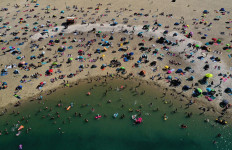An aerial view shows people cooling off at the Silbersee 2 lake in Haltern am See, western Germany on August 7, 2020 as temperatures topped 36 degrees Celsius.
