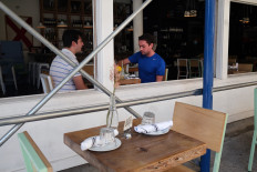 People dine inside a restaurant in Little Italy as New York City restaurants are allowed to open their doors to 25 percent capacity on September 30, 2020 in New York City. 