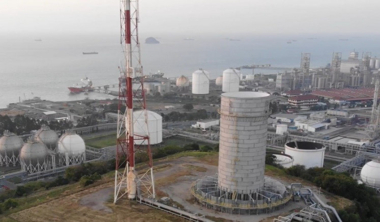 A fine mist obscures the horizon off the facilities of Chandra Asri Petrochemical, Indonesia’s largest publicly listed energy company, in Cilegon, Banten, in this undated photo.