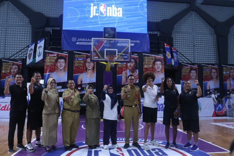 United:  Jr. NBA Asia Coach Natalia Andre (third right) poses for a photograph with her fellow basketball coaches alongside East Java Youth and Sports Agency head Supratomo (fourth right) at the opening of the Jr. NBA Coaches Academy in the CLS Kertajaya sports hall in Surabaya, East Java, on Feb. 10. The program seeks to help sports educators in Indonesia enrich their basketball teaching skills.