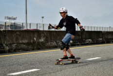 This photo taken on September 9, 2020 shows longboarder and cancer survivor Nongluck Chairuettichai, also known as Jeab, during a practice session on an unfinished highway ramp in Bangkok. 