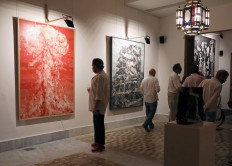 Visitors look at artworks by Ayman Baalbaki and Tagreed Darghouth during a collective exhibition entitled 'Beirut Year Zero', in which some of the proceeds will be donated to the Lebanese Red Cross, who will support families affected by the port explosion, at Arthaus Beirut, Lebanon, on October 2, 2020. 